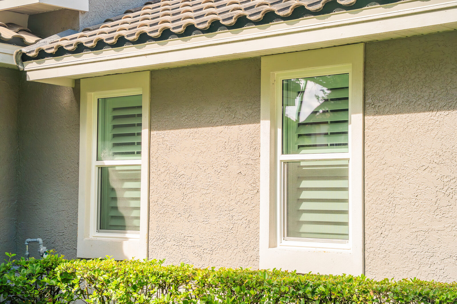Double hung windows — stucco home
